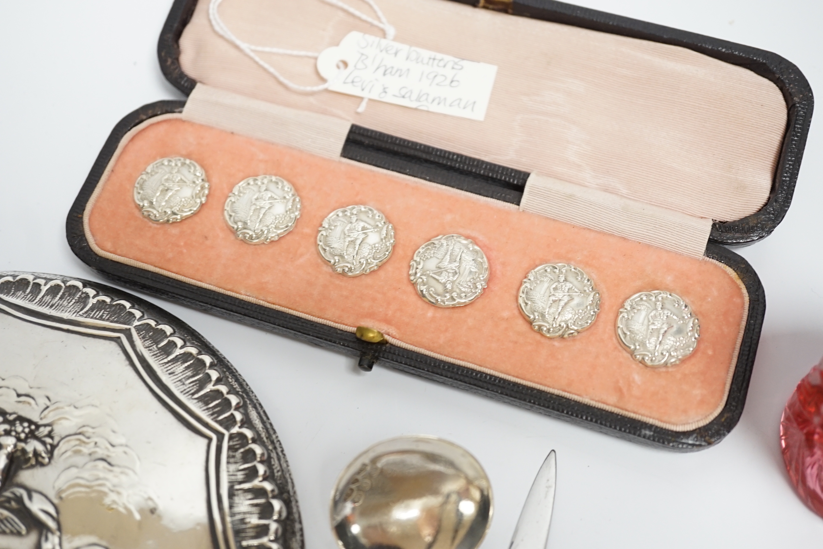 Sundry small silver including a cased set of six late Victorian silver buttons, Birmingham, 1900, a George V silver rattle bell, a silver hand mirror, wine label, scent bottle, etc.